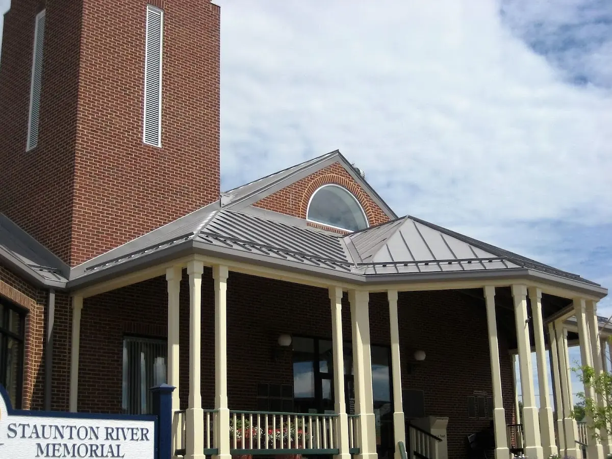 Skilled roofing craftsmen working on a residential roof in Galeton